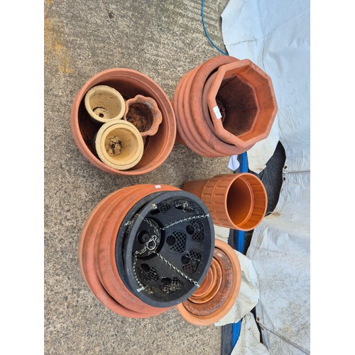 21 - A large selection of plastic and terracotta plant pots