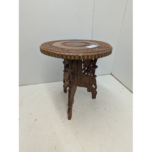 464 - A small carved tripod occasional table