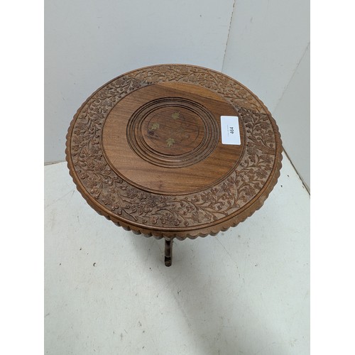 464 - A small carved tripod occasional table