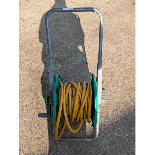 220 - Garden hose on a wheeled reel.