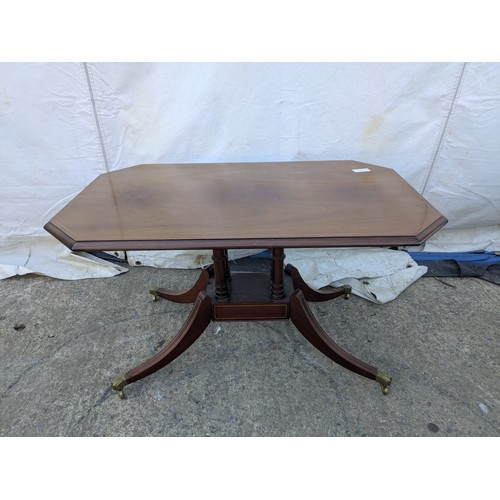 617 - Mahogany veneered antique styled occasional table. With brass lions paw casters.