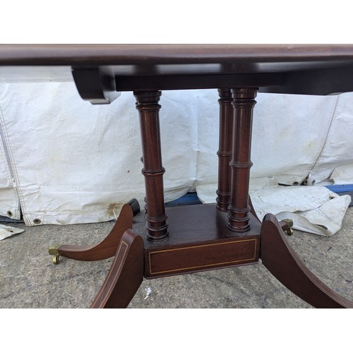 617 - Mahogany veneered antique styled occasional table. With brass lions paw casters.