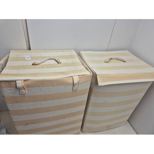 634 - Two yellow and white striped laundry hampers