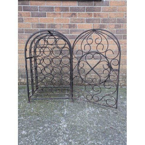 643 - An antique 23 bottle wrought iron wine rack, with latching door and charming detail