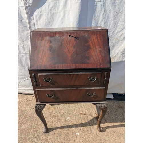 656 - An antique mahogany bureau with ornate carved legs, underlying drawers and interior compartments