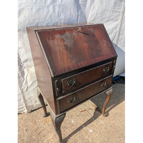 656 - An antique mahogany bureau with ornate carved legs, underlying drawers and interior compartments