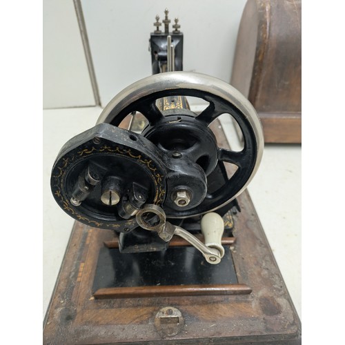 1015 - Antique Victa hand crank sewing machine in a wooden case