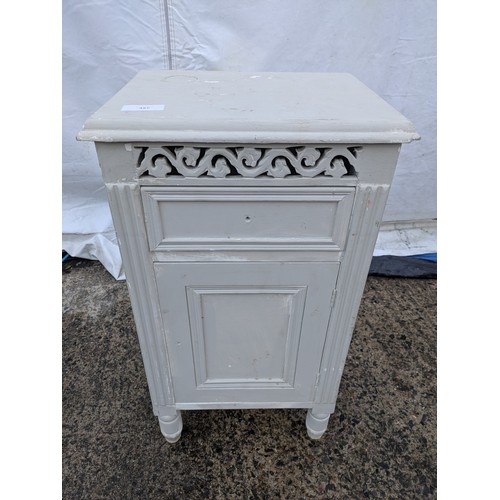 673 - A painted pine storage cabinet