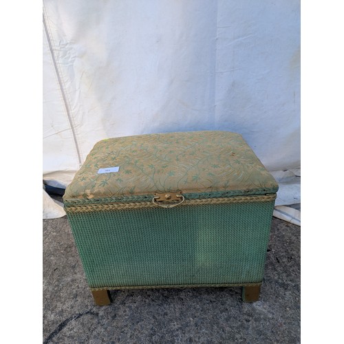 678 - A wicker storage box with a padded Florally upholstered seated top