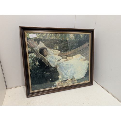 2144 - A framed print of a lady laying in a hammock reading a book - Munnings 1908