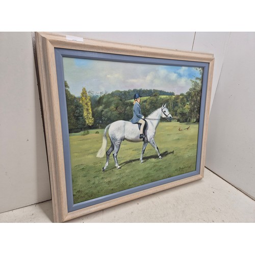 438 - A well executed oil on canvas painting of a lady riding a horse - signed Joan Marshall 1999