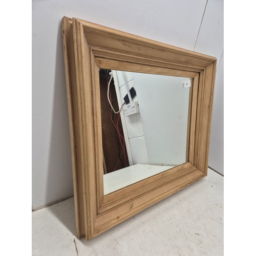 440 - A wall hanging mirror in a thick Bevelled pine frame