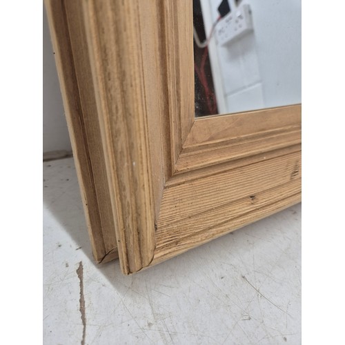 440 - A wall hanging mirror in a thick Bevelled pine frame