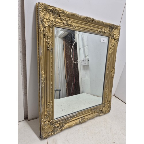 441 - A Bevelled edge mirror in a gold ornate frame