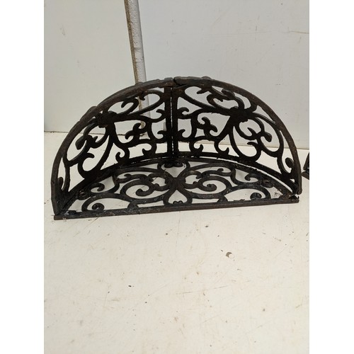 204 - A pair of cast iron wall mounted planters