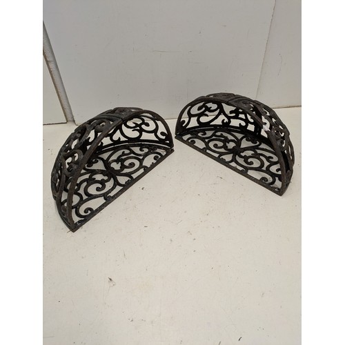 204 - A pair of cast iron wall mounted planters
