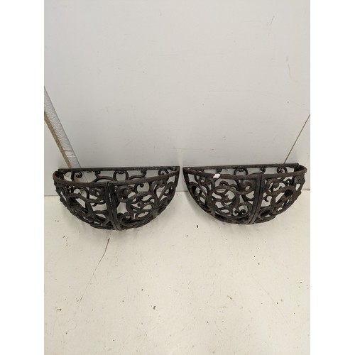 204 - A pair of cast iron wall mounted planters