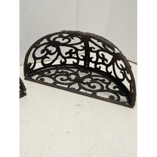 204 - A pair of cast iron wall mounted planters