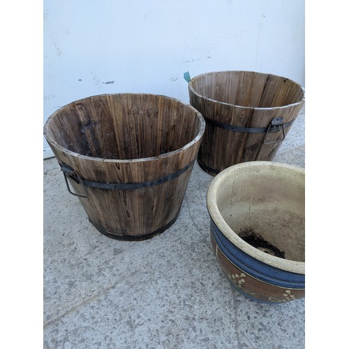 221 - A selection of garden pots including a pair of barrel style pots