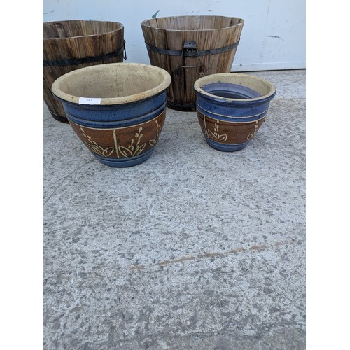 221 - A selection of garden pots including a pair of barrel style pots
