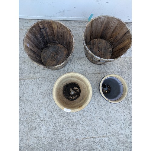221 - A selection of garden pots including a pair of barrel style pots