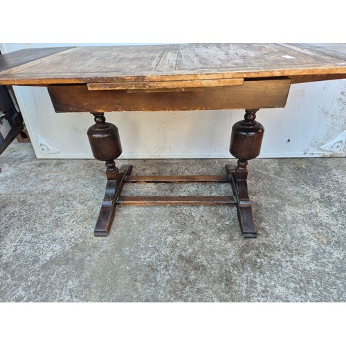 29 - A 1950's oak drawer leaf dining table