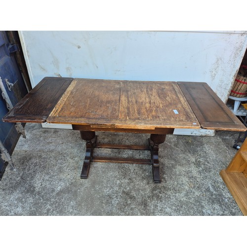 29 - A 1950's oak drawer leaf dining table