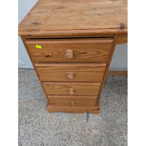 654 - A pine desk with 8 drawers