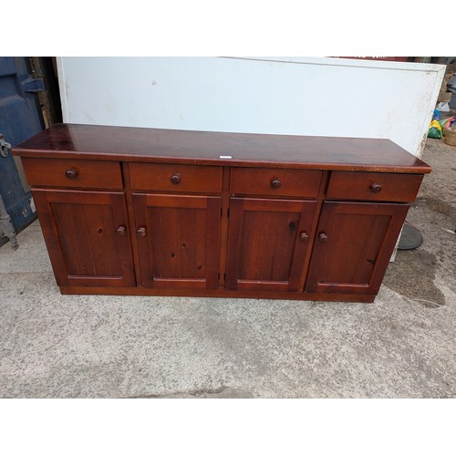 694 - A pine side unit with 4 drawers and 2 cupboard spaces