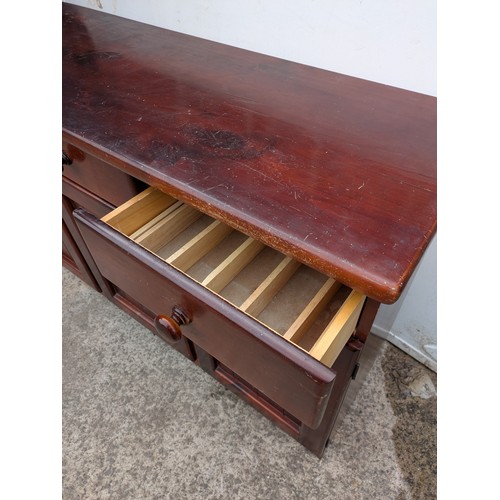 694 - A pine side unit with 4 drawers and 2 cupboard spaces