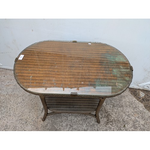 668 - A vintage genuine Lloyd loom side table with underlying shelf