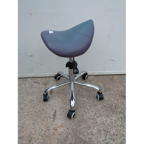 674 - An adjustable wheeled stool with a blue leather seat base