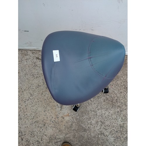 674 - An adjustable wheeled stool with a blue leather seat base