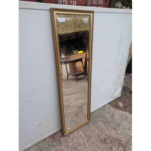 678 - A bevelled edge dressing mirror in am ornate gold gilt floral carved frame