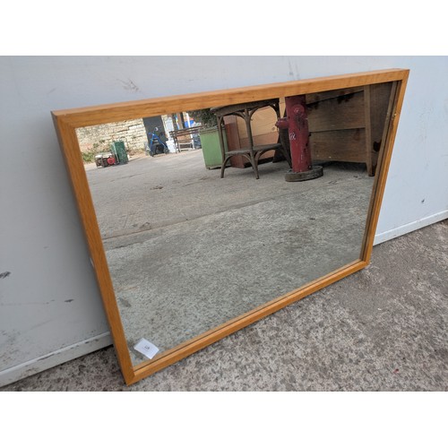 677 - A modern wall mounted mirror in an oak effect frame