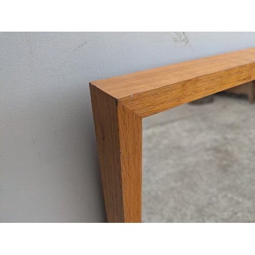 677 - A modern wall mounted mirror in an oak effect frame