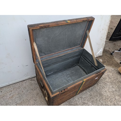 671 - An early 20th century steamer trunk with metal reinforcements