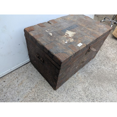 669 - An early 20th century steamer trunk with metal reinforcements