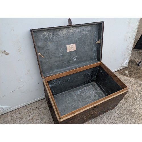 669 - An early 20th century steamer trunk with metal reinforcements