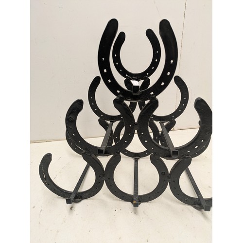 692 - A 6 bottle horseshoe wine bottle rack