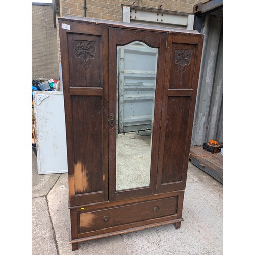655 - A vintage mahogany wardrobe with bevelled dressing mirror