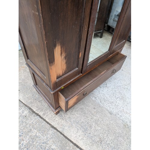 655 - A vintage mahogany wardrobe with bevelled dressing mirror