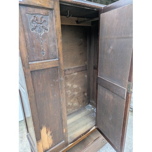 655 - A vintage mahogany wardrobe with bevelled dressing mirror