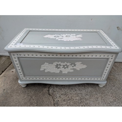 656 - A painted pine storage trunk with floral carvings
