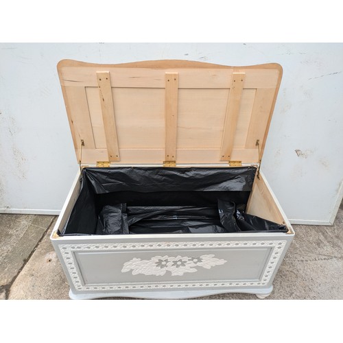 656 - A painted pine storage trunk with floral carvings