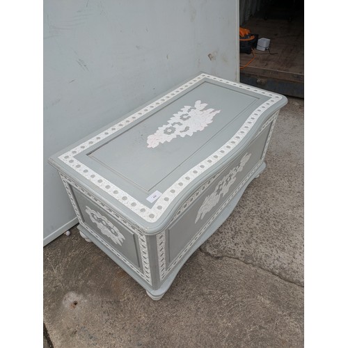 656 - A painted pine storage trunk with floral carvings