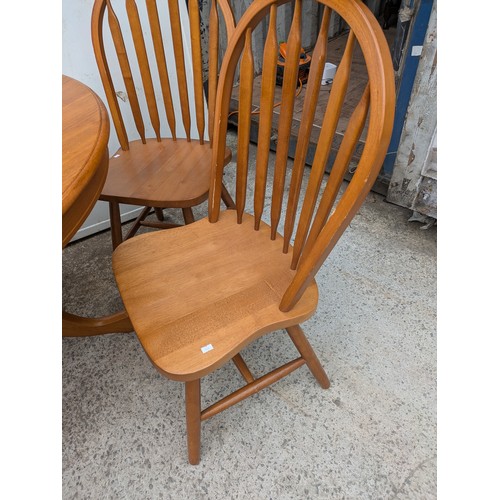 647 - An oak circle dining table with 4 matching dining chairs