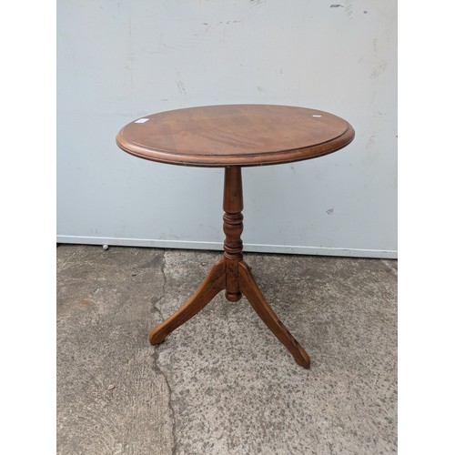 667 - A vintage oak side table with tripod base
