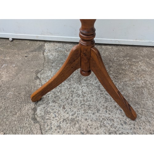 667 - A vintage oak side table with tripod base