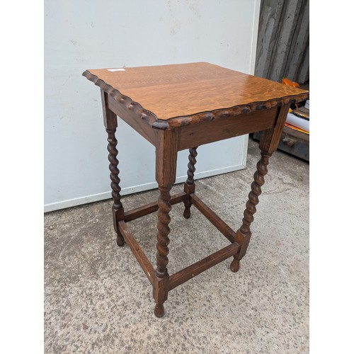 672 - A vintage oak side table with barley twist legs